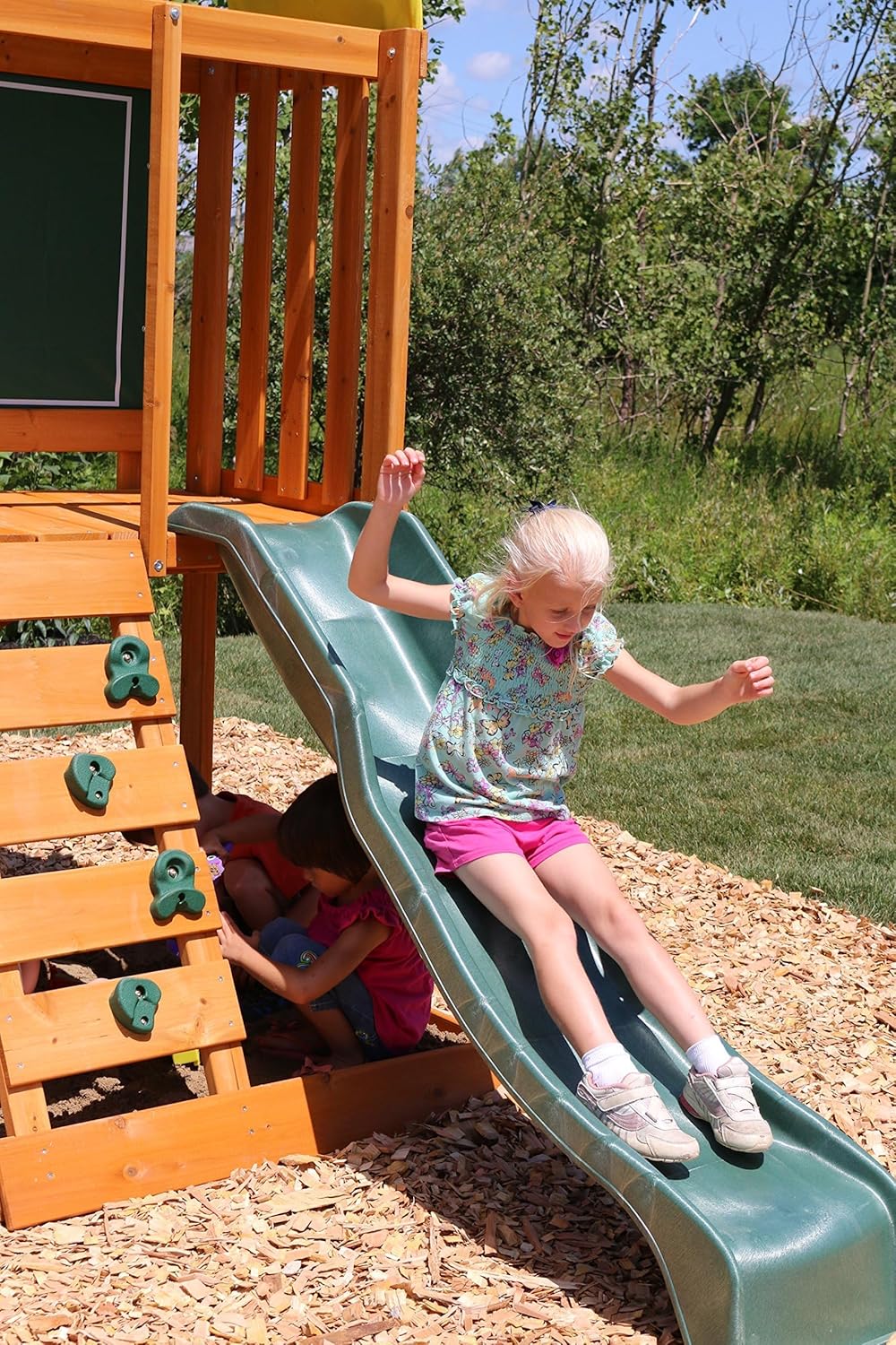KidKraft Ainsley Outdoor Swing Set / Playset with High-Rail Wave Slide, Rock Wall, Upper-Level Clubhouse and Belt Swings, Multicolor Wooden Backyard Playset for Kids Ages 3 to 10