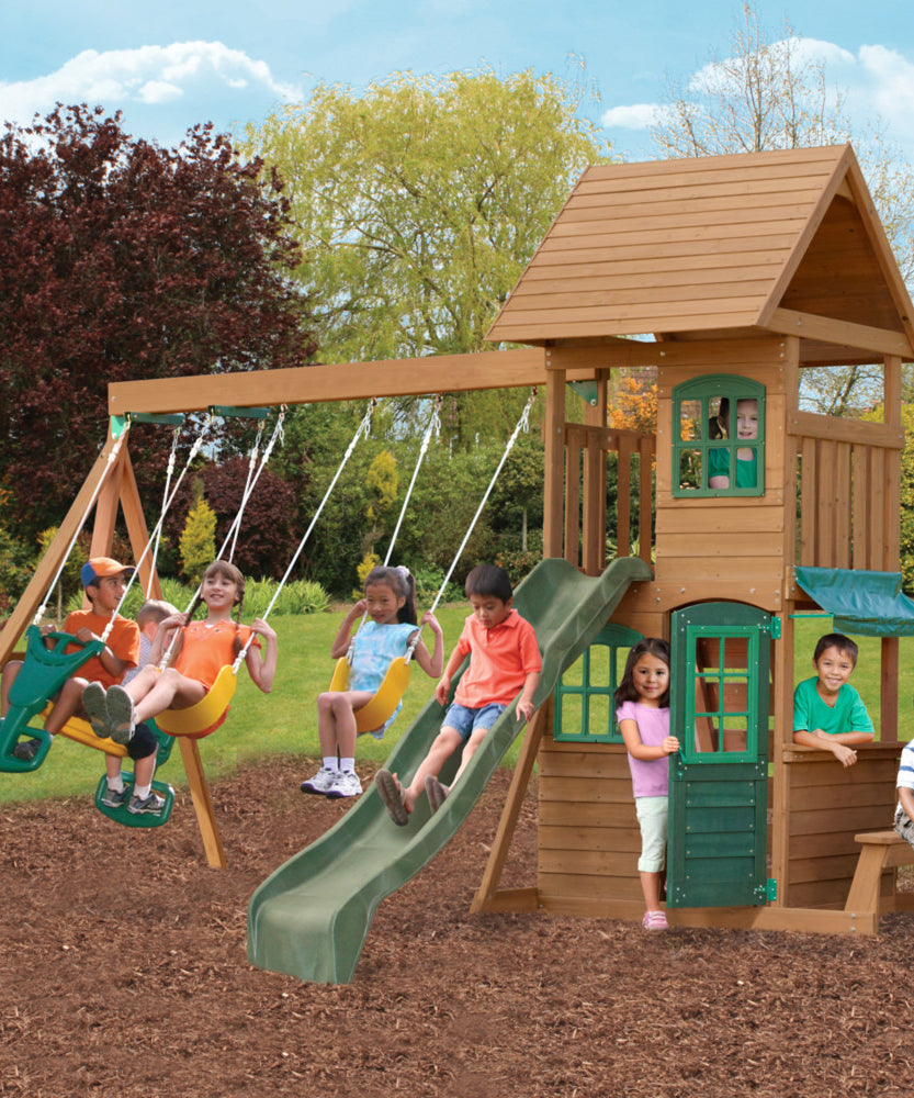 KidKraft Windale Fort Wooden Outdoor Swing Set, Playset with Clubhouse, Swings, High-Rail Wave Slide, Glider, Shaded Café Table and Bench, Multi-Level Backyard Play for Kids Ages 3 to 10
